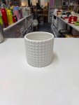 White ceramic planter features a distinctive geometric diamond or pineapple-like textured pattern